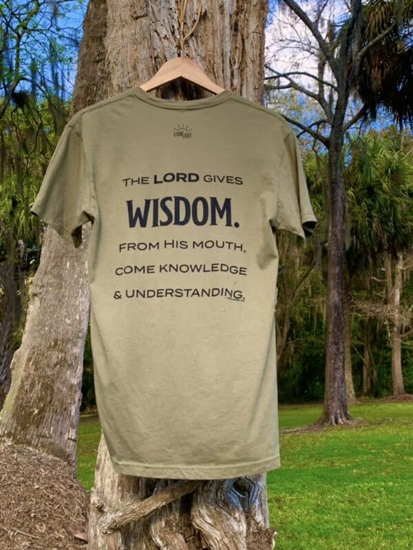 Back of Livin' Light's "Wisdom Comes from Above" olive green, short-sleeved T-shirt with tree background. Owl with wings spread and piercing eyes which illustrates Bible verse Proverbs 2:6.
